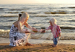 Son passing pebbles to his mother