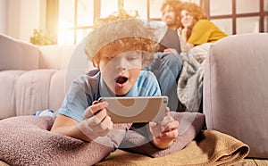 Son plays online with smartphone. Concept of addiction, dependency, problem