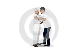 Son shaking hand and asking for forgiveness to father isolated over white background