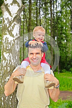 Son sits on shoulders at father