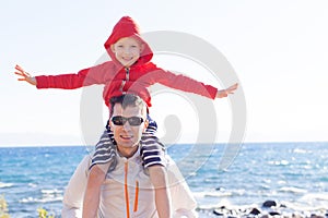 Son sitting on father's shoulders