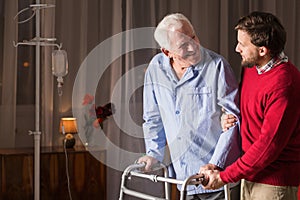 Son supporting disabled father