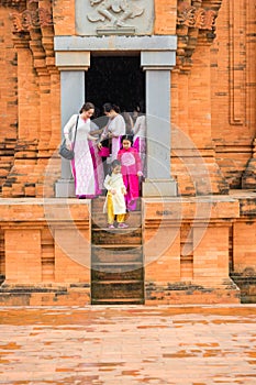 Son Tay, Vietnam - Nov 15, 2015: Vietnamese tourists in traditional dress Ao Dai visiting Champa temple - Hidu Tower in Ethnic vil