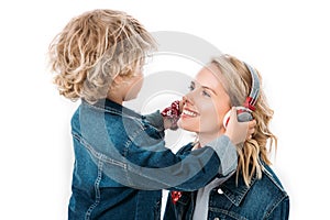 son wearing headphones on mother to listen to music