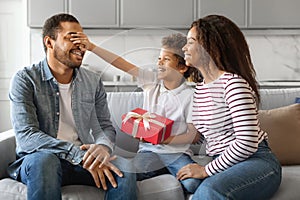 Son And Wife Greeting Young Black Man With Father& x27;s Day, Giving Gift