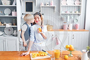 Son and young mother in the kitchen eating Breakfast.