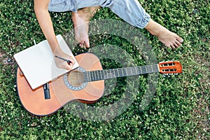 Songwriter create and writing notes,lyrics in the book grass at parks photo