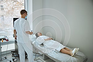 Sonographer beginning an ultrasound exam of the patient