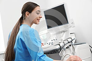 Sonographer operating modern ultrasound machine photo