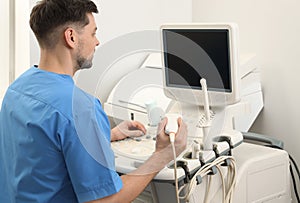 Sonographer operating modern ultrasound machine i