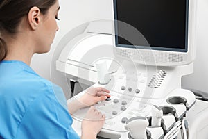 Sonographer operating modern ultrasound machine photo