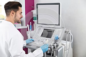 Sonographer using modern ultrasound machine photo