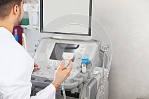 Sonographer using modern ultrasound machine, space for text