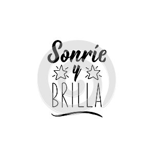 Smile and shine - in Spanish. Lettering. Ink illustration. Modern brush calligraphy photo
