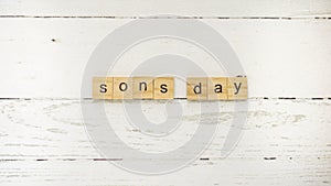 Sons day.words from wooden cubes with letters photo
