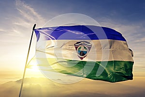 Sonsonate Department of El Salvador flag textile cloth fabric waving on the top sunrise mist fog