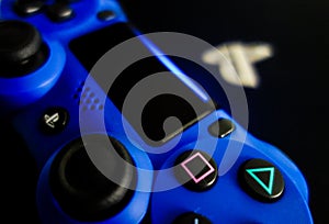 Sony Playstation logo illuminated on blue light from game controller