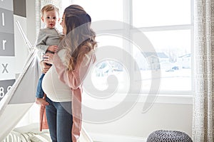 Soon therell be two of them. a pregnant woman bonding with her toddler son at home.