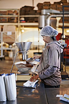 Soon to be in your cup from the production floor. a worker in a coffee packaging and distribution warehouse.