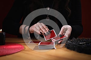 Soothsayer predicting future with cards at table indoors, closeup