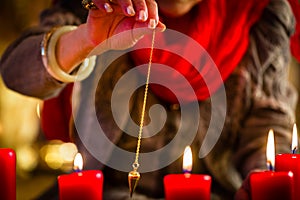 Soothsayer during a Seance or session with pendulum photo