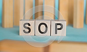 SOP - acronym from wooden blocks with letters, abbreviation SOP standard operating procedure concept
