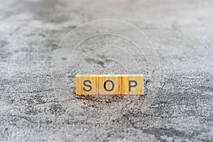 SOP Standard Operating Procedure text on wooden block