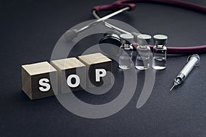 SOP text or Standard Operating Procedure on wooden cube