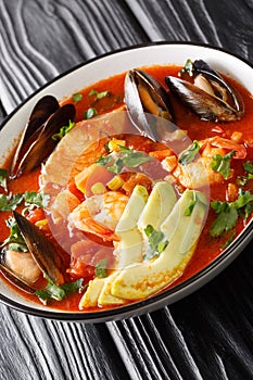 Sopa de Mariscos Seafood Soup closeup in the plate. Vertical photo