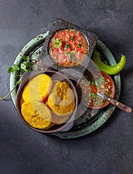 Sopaipilla. Latin American food. Traditional chilean homemade pumpkin sopaipillas with typical salsas - chancho en photo