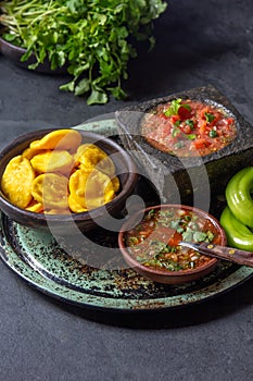 Sopaipilla. Latin American food. Traditional chilean homemade pumpkin sopaipillas with typical salsas - chancho en photo