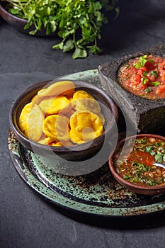 Sopaipilla. Latin American food. Traditional chilean homemade pumpkin sopaipillas with typical salsas - chancho en photo