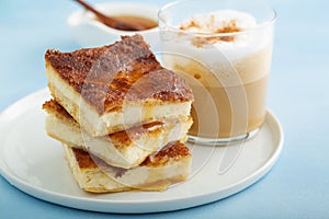 Sopapilla cheesecake bars with cinnamon drizzled with honey