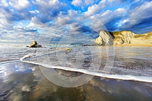 Sopelana beach with wave foam and reflections