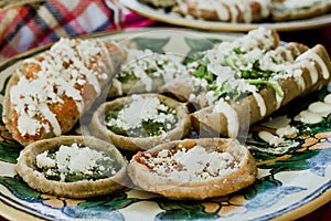 Sopes, tacos dorados and flautas de pollo, Mexican food, spicy sauce in Mexico