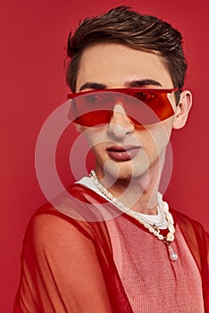 sophisticated androgynous man with red stylish