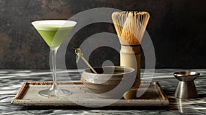 A sophisticated matcha martini stands tall, its frothy top complementing the traditional matcha tea set and bamboo whisk