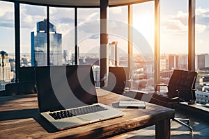 Sophisticated modern office with city view, laptop on table, unique chairs and sunlight.