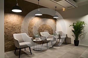 Sophisticated office with textured wall, chic seating, pendant lights, potted plant, and tiled floor