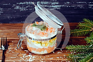 Sophisticated salmon salad with parmesan and fork on a wooden background