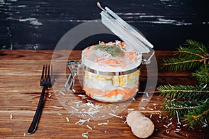 Sophisticated salmon salad with parmesan and fork on a wooden background