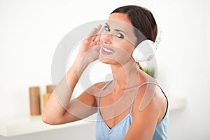 Sophisticated woman with headphones looking happy