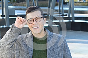 Sophisticated young ethnic man adjusting his eyeglasses