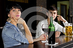 Sophisticated young woman drinking at a bar