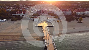 Sopot resort in Poland. Wooden pier (molo) with promenade, marina, yachts, pirate tourist ship, beach, old lighthouse.