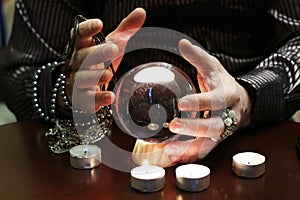 Sorcerer hands over a transparent crystal ball fortune-telling for future