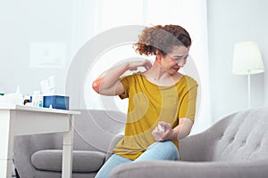Young woman suffering from a neck sprain photo