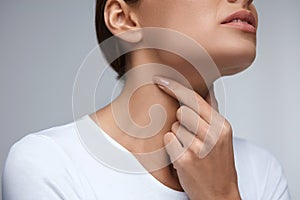 Sore Throat. Closeup Beautiful Woman Hands And Neck. Throat Pain
