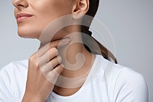 Sore Throat. Closeup Beautiful Woman Hands And Neck. Throat Pain