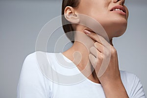 Sore Throat. Closeup Beautiful Woman Hands And Neck. Throat Pain